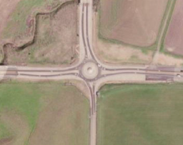 Figure 5-5. Comparison images for the CA12/113 intersection showing the as-built intersection (left image), the calculated illuminance at the as-built intersection (middle image), and a shielded alternative (right image). Both lighting solutions meet the CA roadway standards (red indicates the highest levels and blue indicates the lowest). Image credit: Travis Longcore and Clanton & Associates